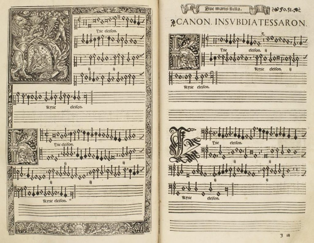 First double-page opening of Morales’s Missa Ave maris stella. The page features an illuminated letter K, depicting a vignette of the Virgin and child in the center, as well as two smaller letter K's each depicting a cherub playing a harp in the center. There is an additional decorative letter K in the final verse, done in exquisite calligraphy.